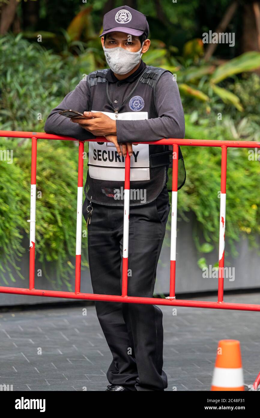 Security guard wearing face mask at barrier during Covid 19 pandemic