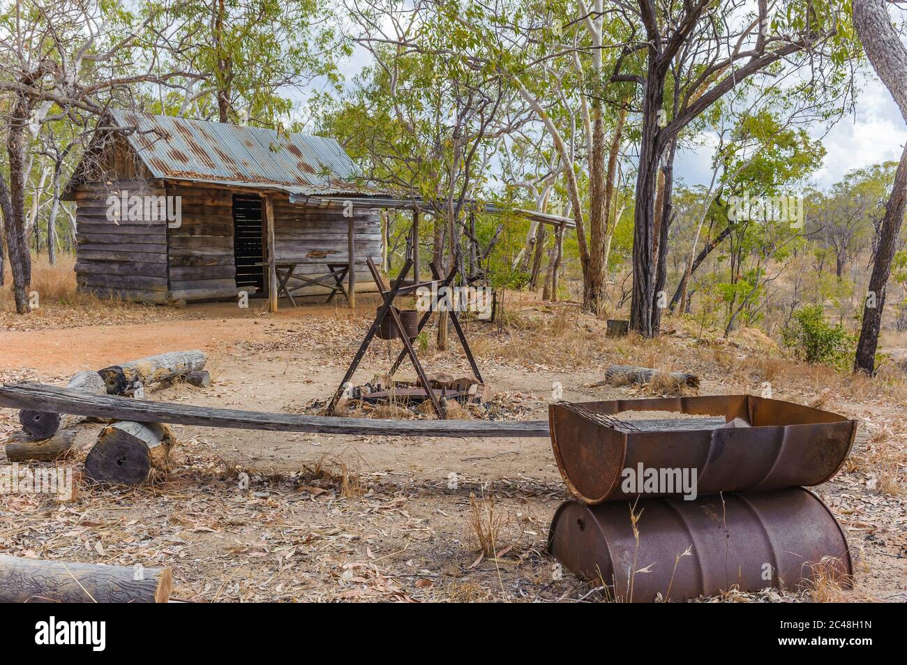 A replica old early pioneer log cabin and traditional outback, outdoor kitchen at Undara, North-west Queensland in Australia. Stock Photo