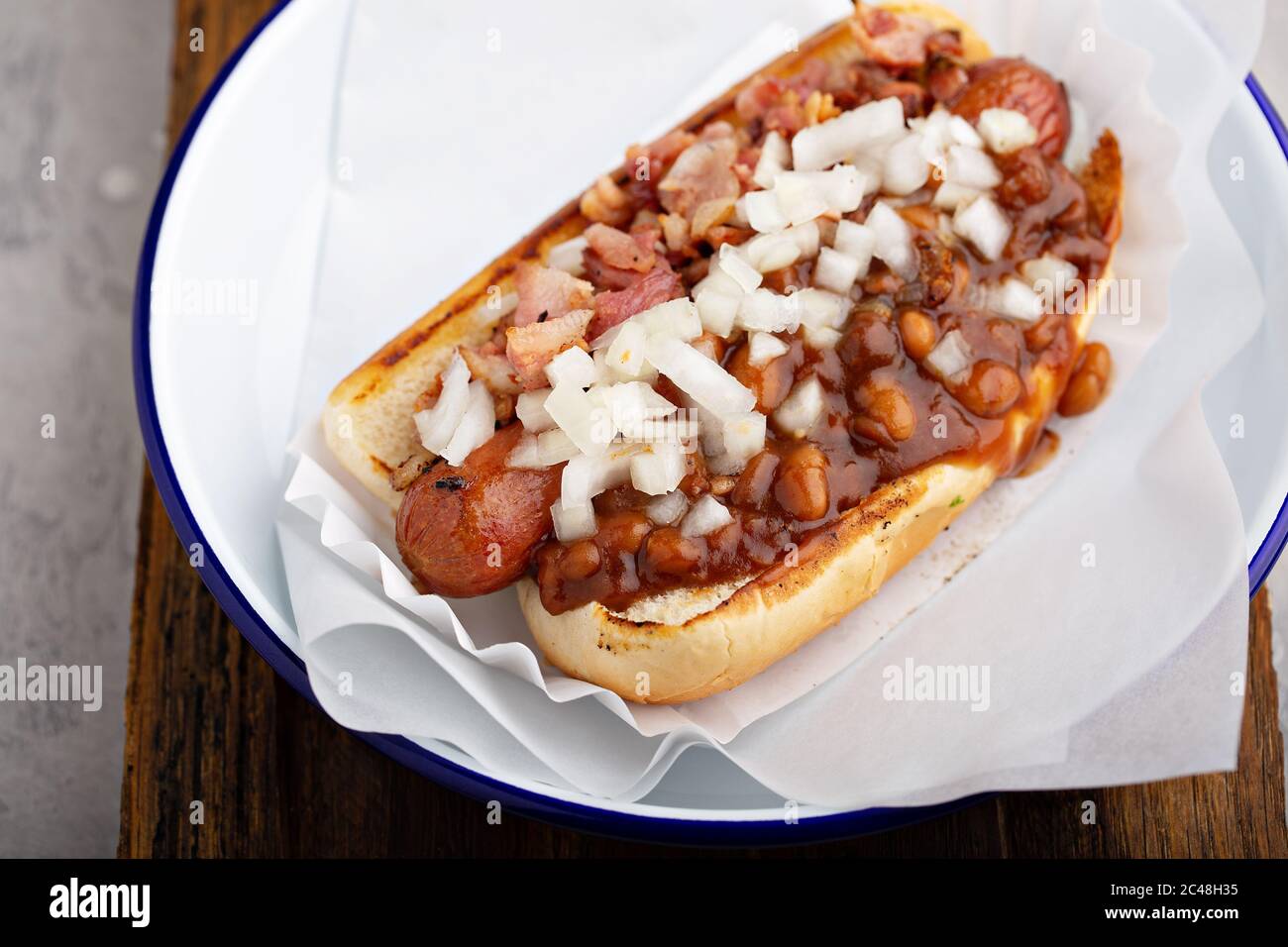Chili hot dog with beans and onion Stock Photo Alamy