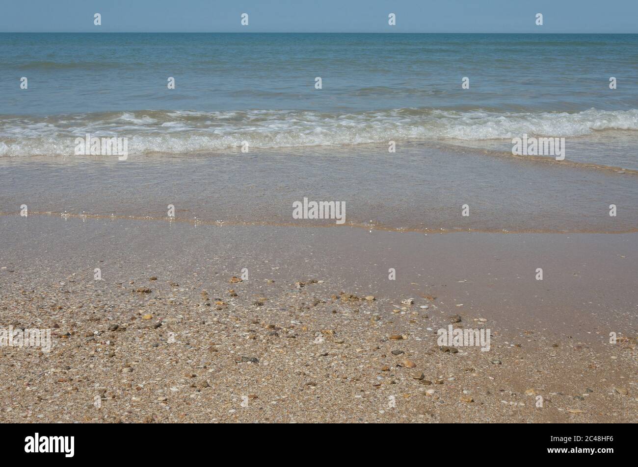 Sun on waves reaching beach hi-res stock photography and images - Alamy