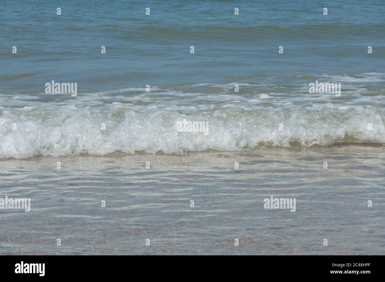Sun on waves reaching beach hi-res stock photography and images - Alamy