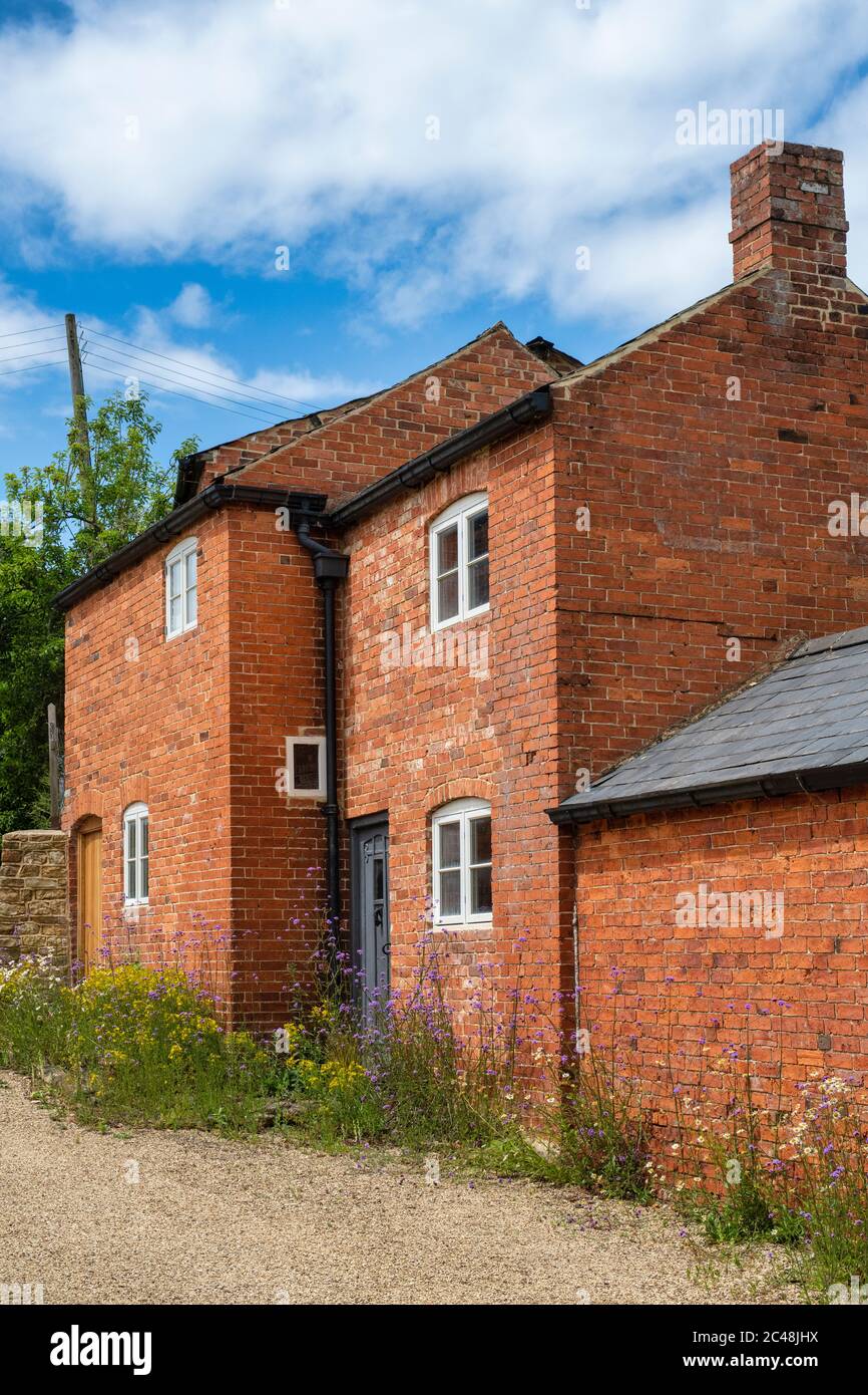 Red brick cottages and flowers. Upper Brailes, Warwickshire, England Stock Photo