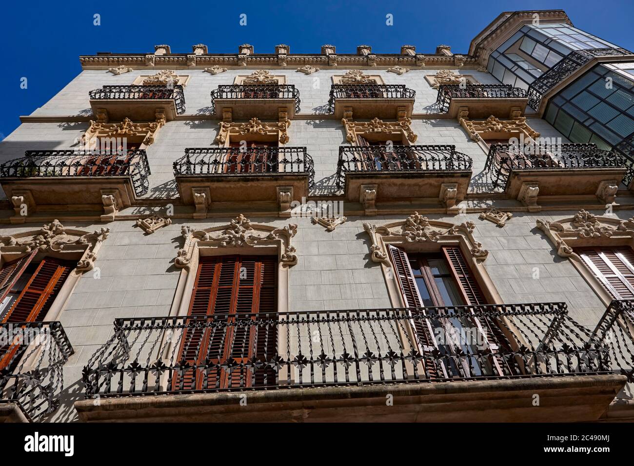 Balconies with elaborate wrought-iron fencing on the old residential multi-storey building in Reus, Catalonia, Spain. Stock Photo