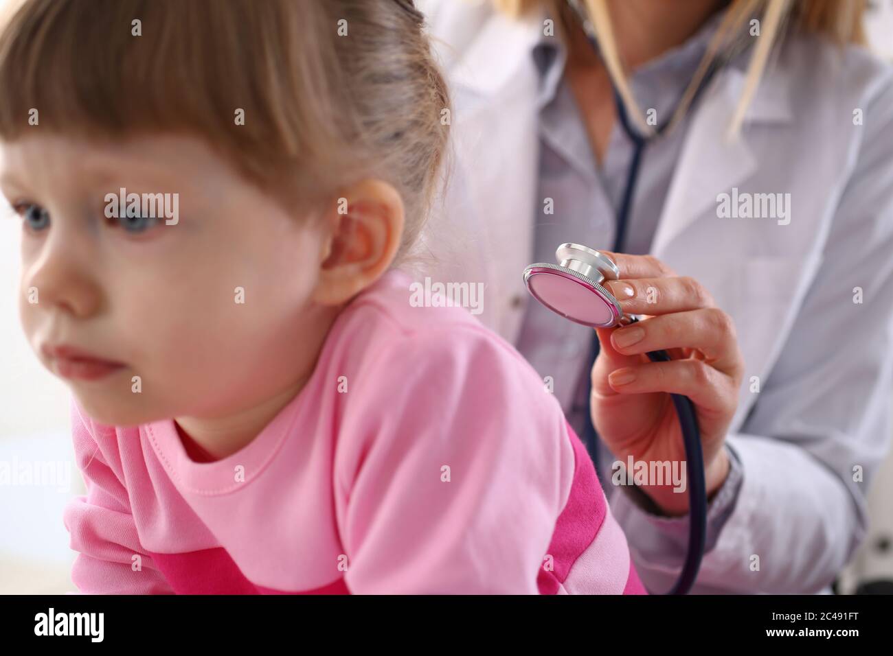 Female doctor checking breath of child with stethoscope Stock Photo Alamy