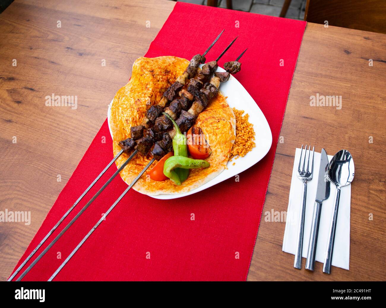 Turkish kebab lamb meat on skewer. with vegetables and rice on a