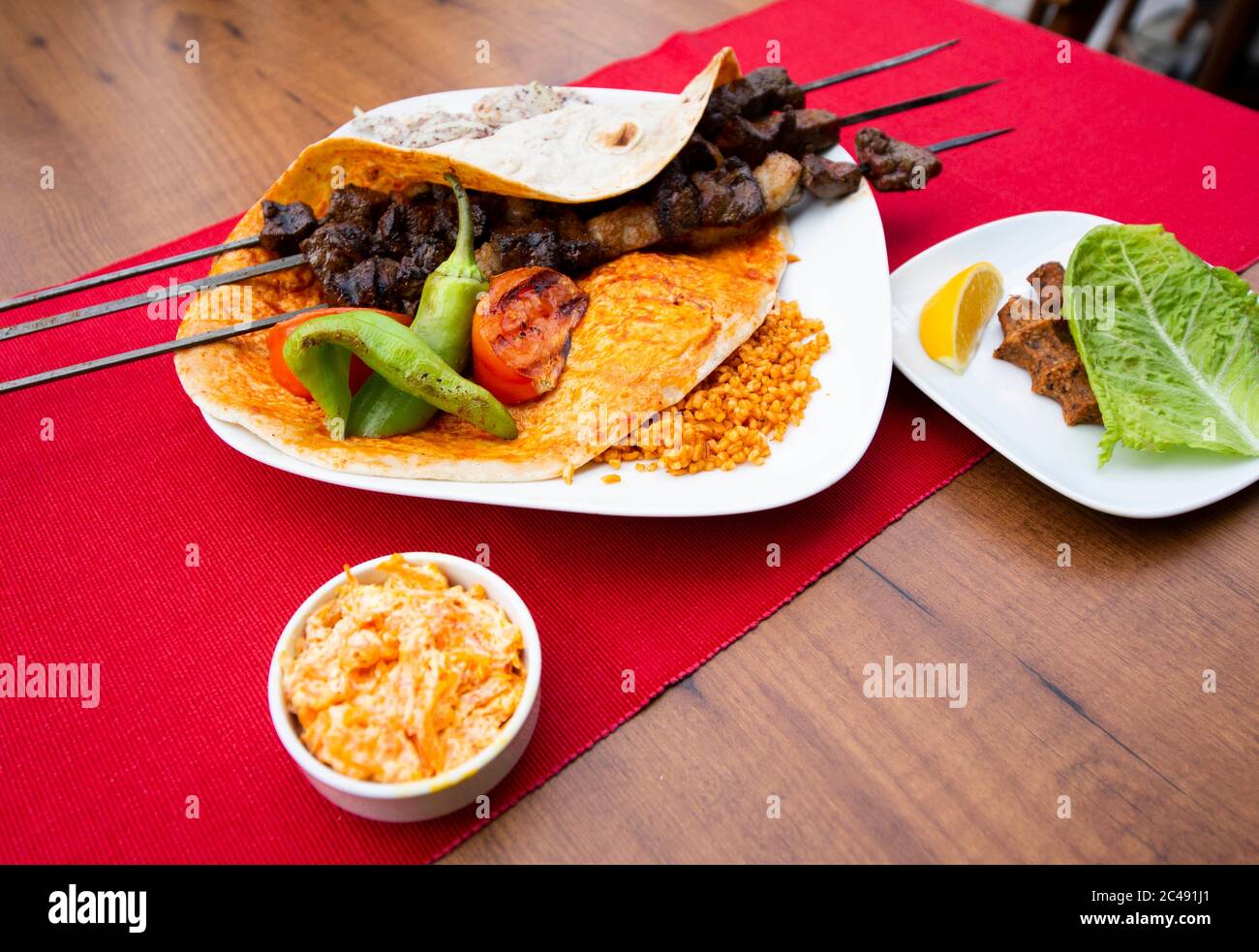 Turkish kebab lamb meat on skewer. with vegetables and rice on a