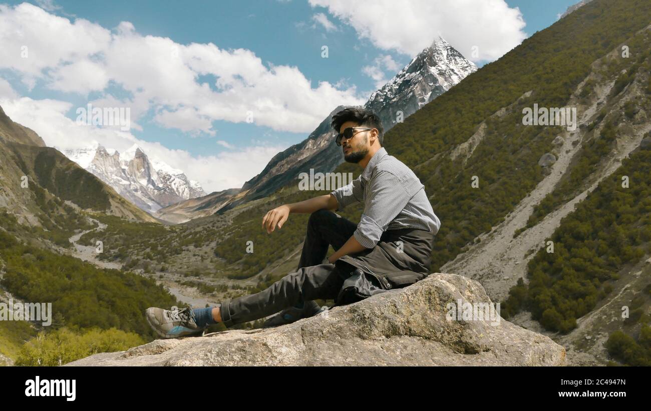 Young man posing with the mountains in the background Stock Photo