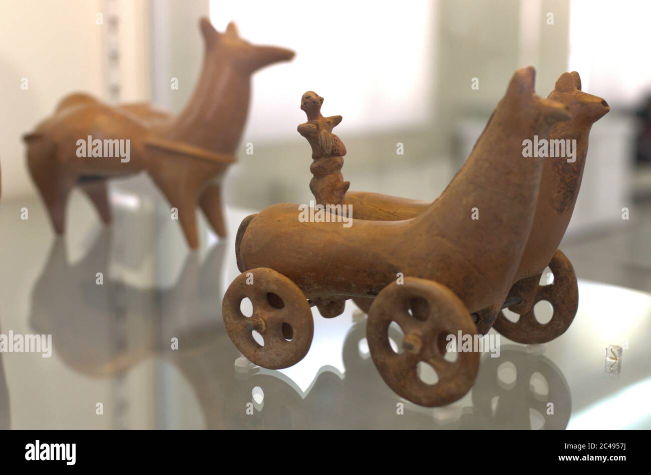 Ancient wheel carriage Parthian or Mesopotamian clay statue at the National Museum Of Iran Stock Photo