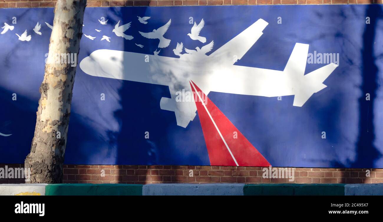 Iranian women by new anti-US mural outside former US embassy in TehranI depicting downing of Iran Air Flight 655 Stock Photo