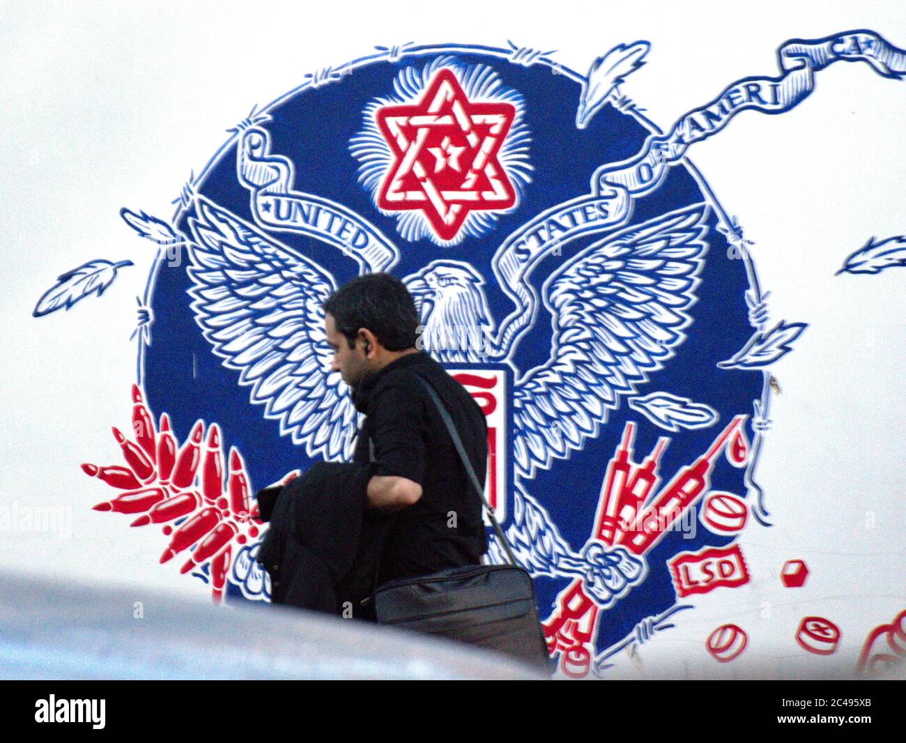 Defaced US seal on mural outside former US embassy in Tehran, Iran Stock Photo