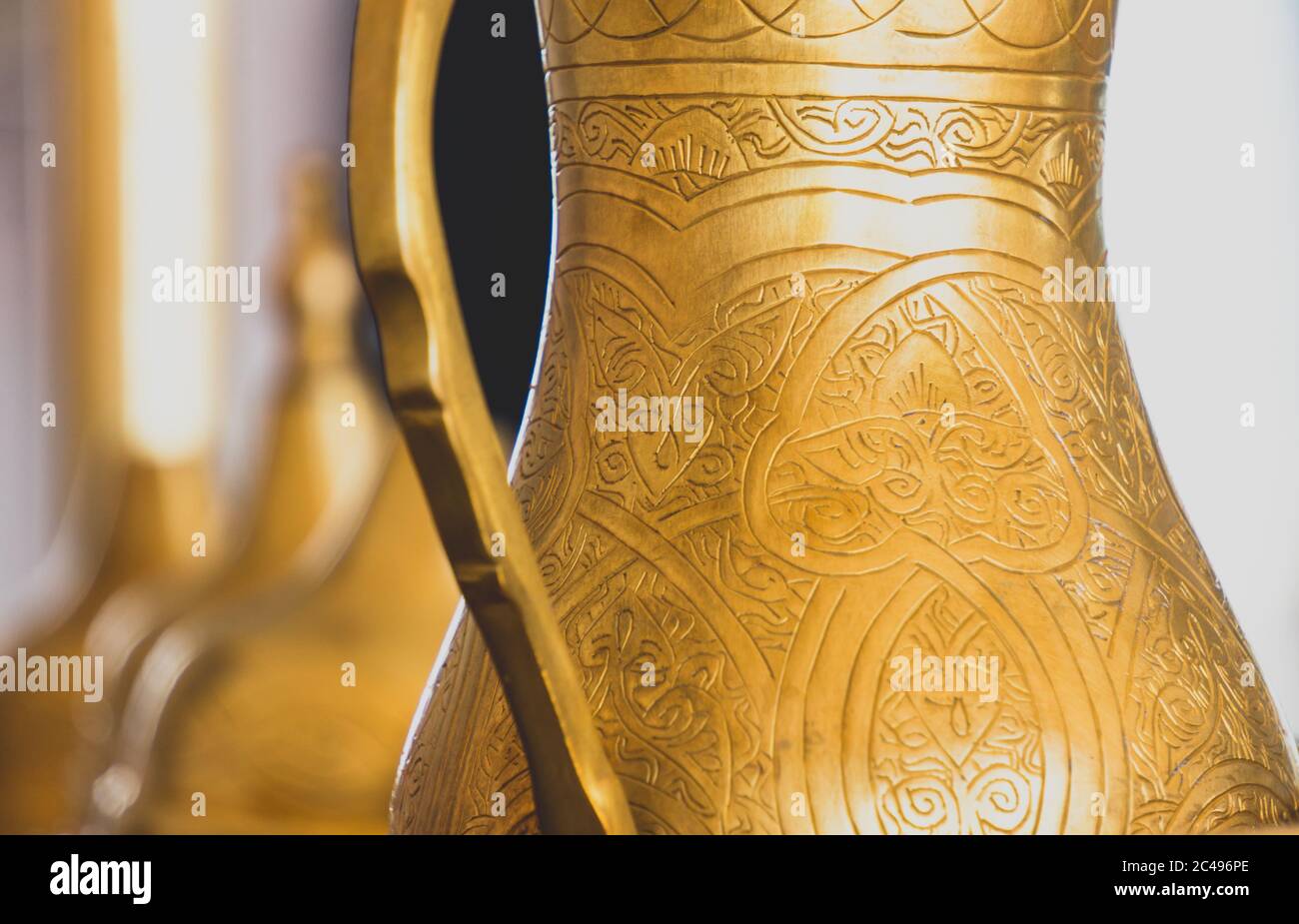 Close-up of golden patterned arabic brass coffee pot. Stock Photo