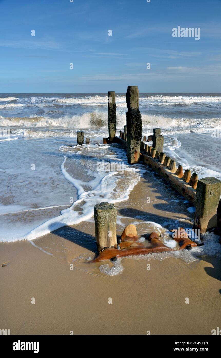 weathered wooden groynes and north sea mundesley north norfolk england Stock Photo