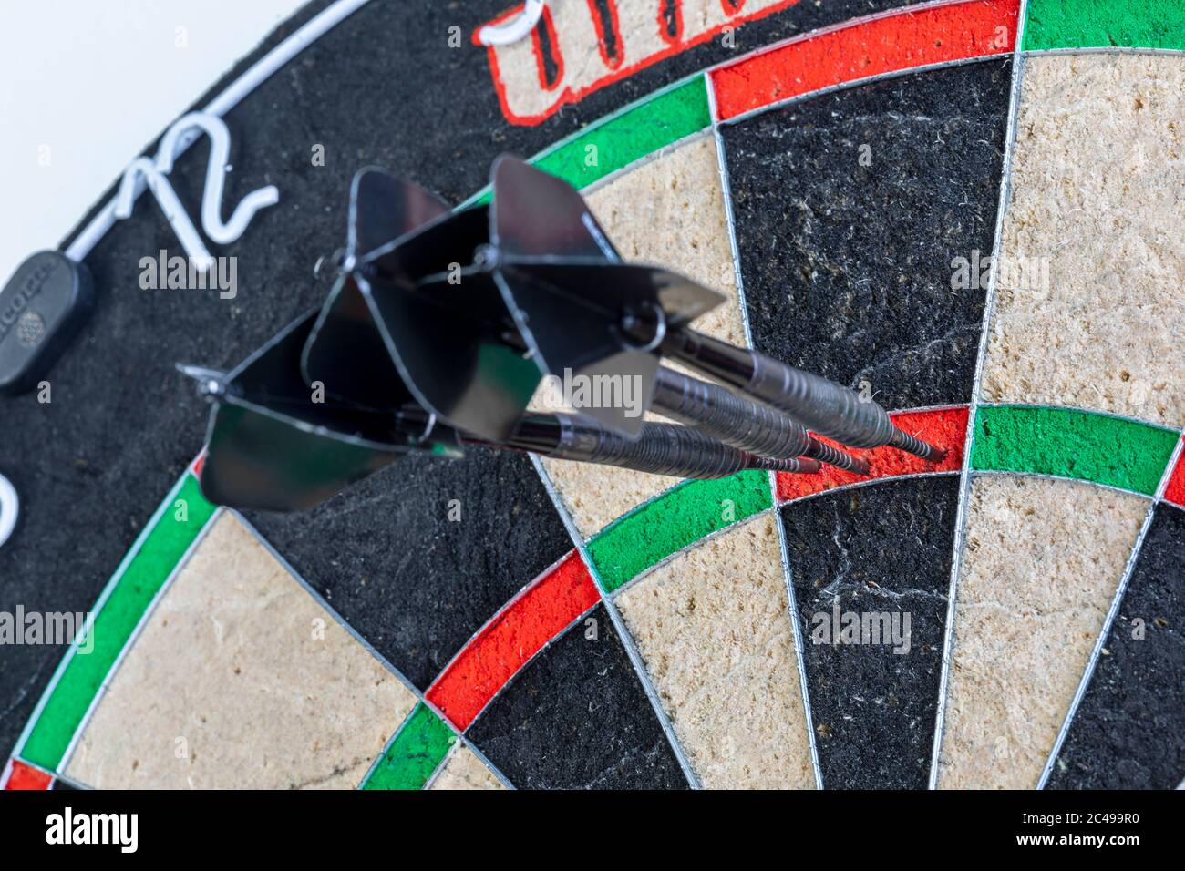 Three darts in triple twenty on a dartboard Stock Photo - Alamy
