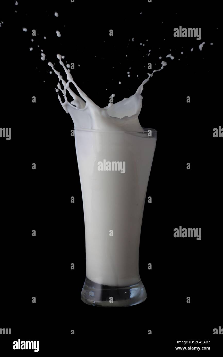 Milk splash in drinking glass Stock Photo - Alamy