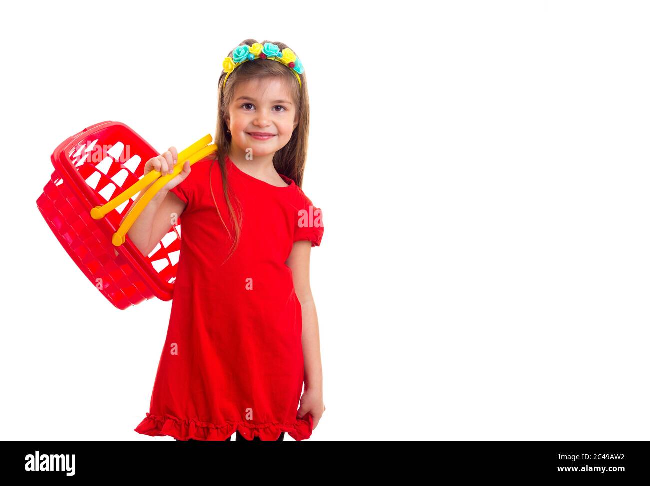 Little girl in red dress with shopping basket Stock Photo