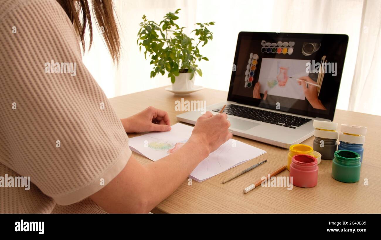 Woman learns to draw online Stock Photo