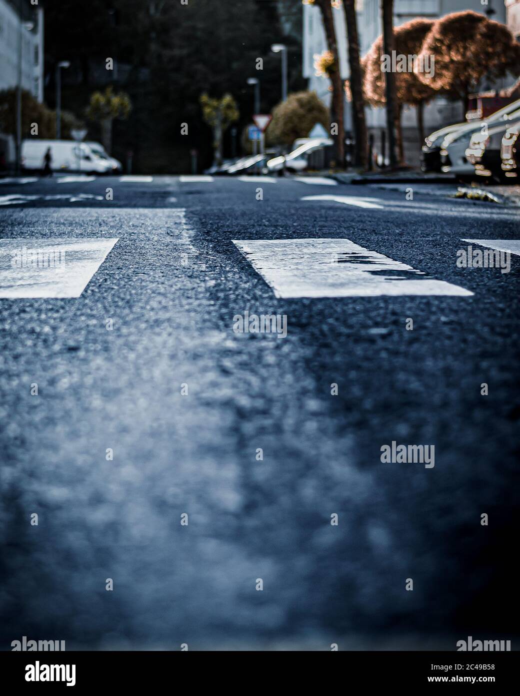 Cars parked along the street with an asphalt road Stock Photo - Alamy