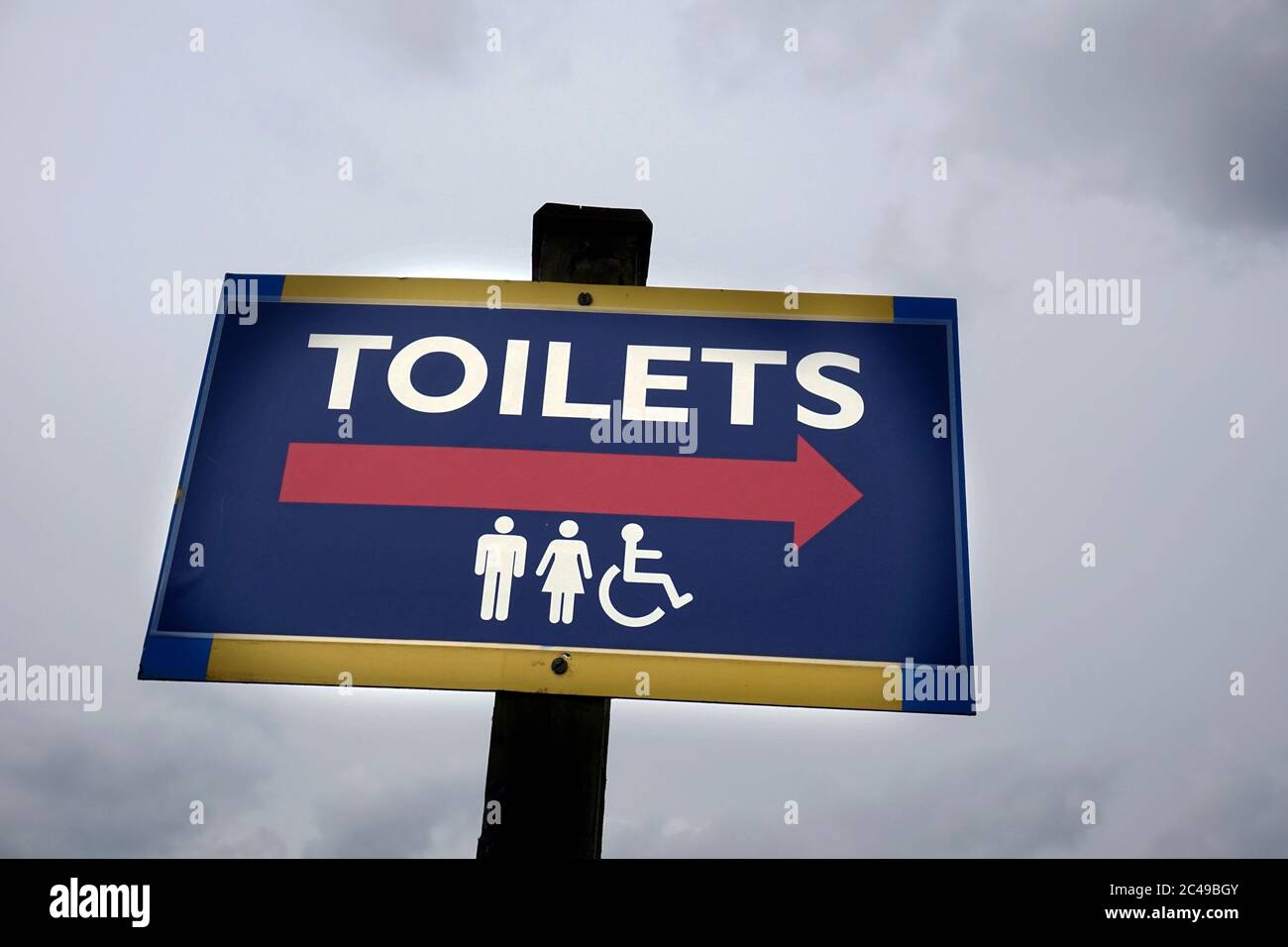 brightly painted public toilet sign Stock Photo