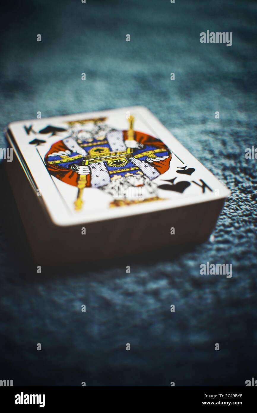A deck of new cards, peak king first, side view on the dark table Stock  Photo - Alamy