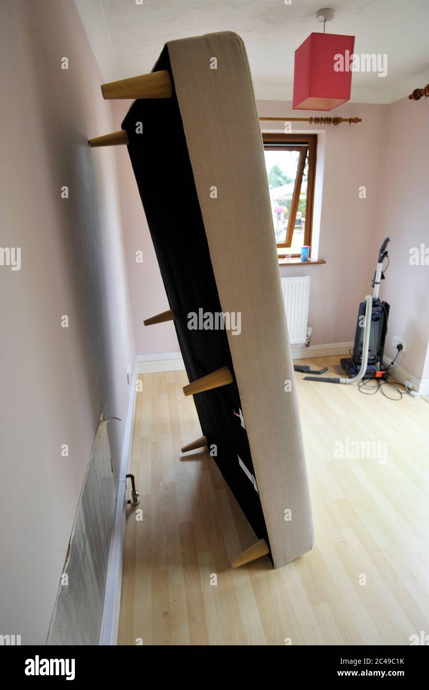 bed leaning against wall Stock Photo Alamy