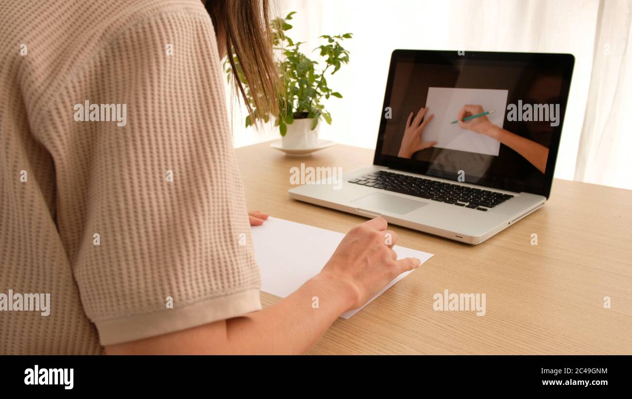 Woman learns to draw online Stock Photo