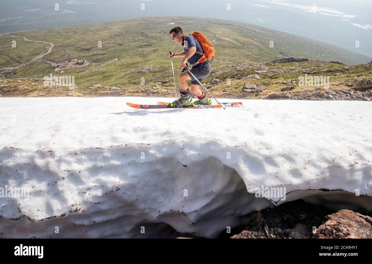 Andy Meldrum, owner of the Glencoe Mountain Resort, skis on some of the remaining snow patches on the slopes of Meall a'Bhuiridh in Glencoe as Thursday could be the UK's hottest day of the year with scorching temperatures forecast to rise even further. Stock Photo