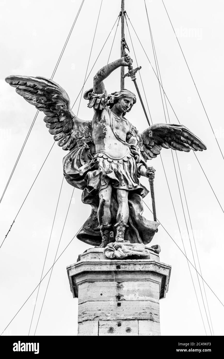 Bronze statue of Michael the Archangel on the top of the Castel Sant'Angelo, Rome, Italy. Black and white image. Stock Photo