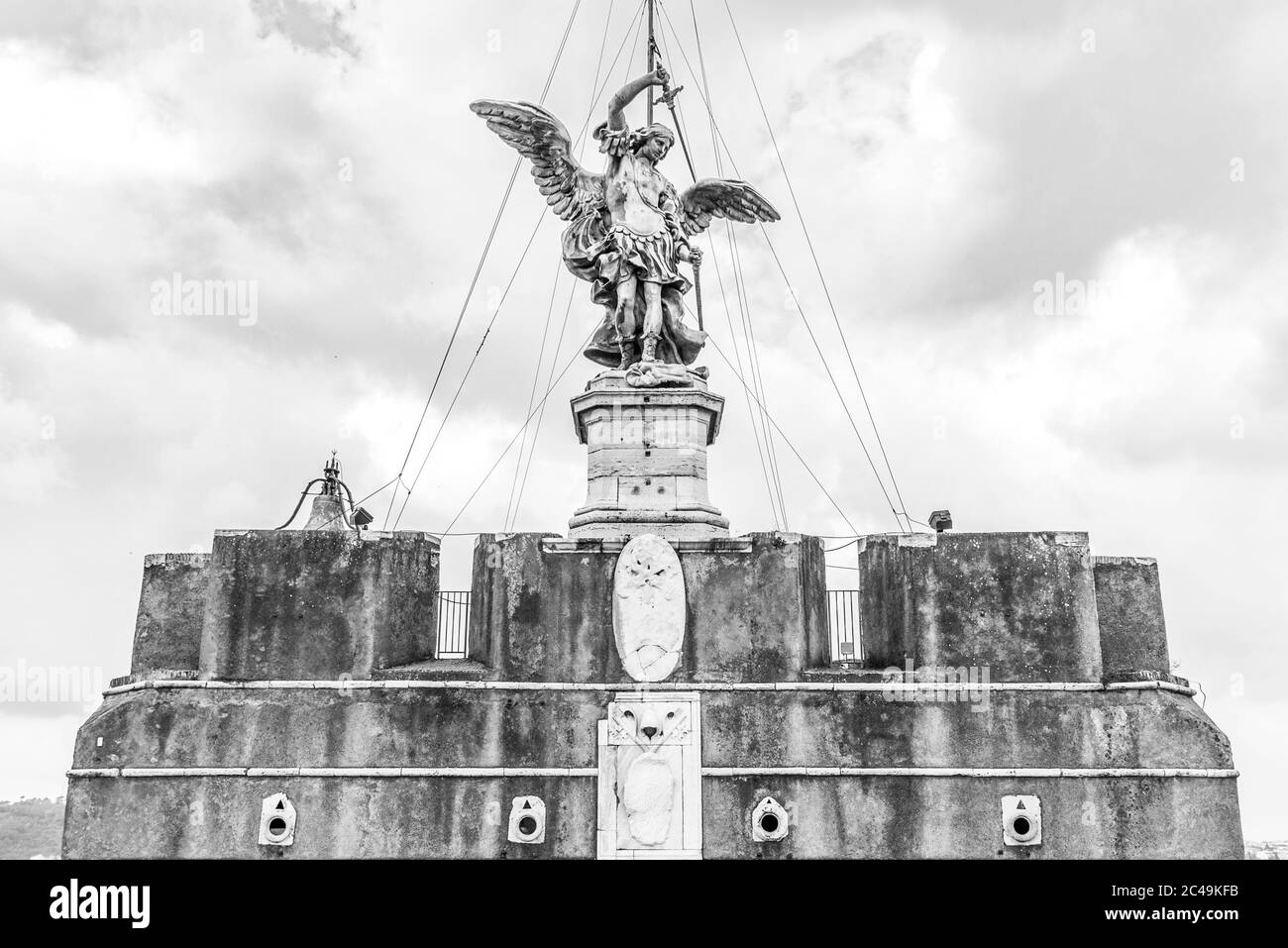 Bronze statue of Michael the Archangel on the top of the Castel Sant'Angelo, Rome, Italy. Black and white image. Stock Photo