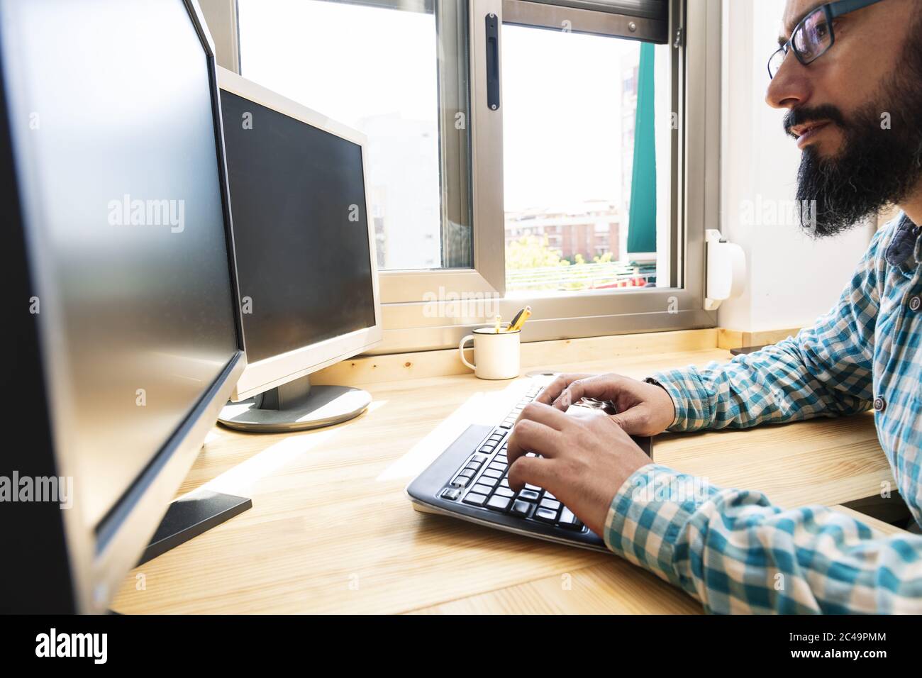 Man Typing At Work On A Computer High Resolution Stock Photography and ...
