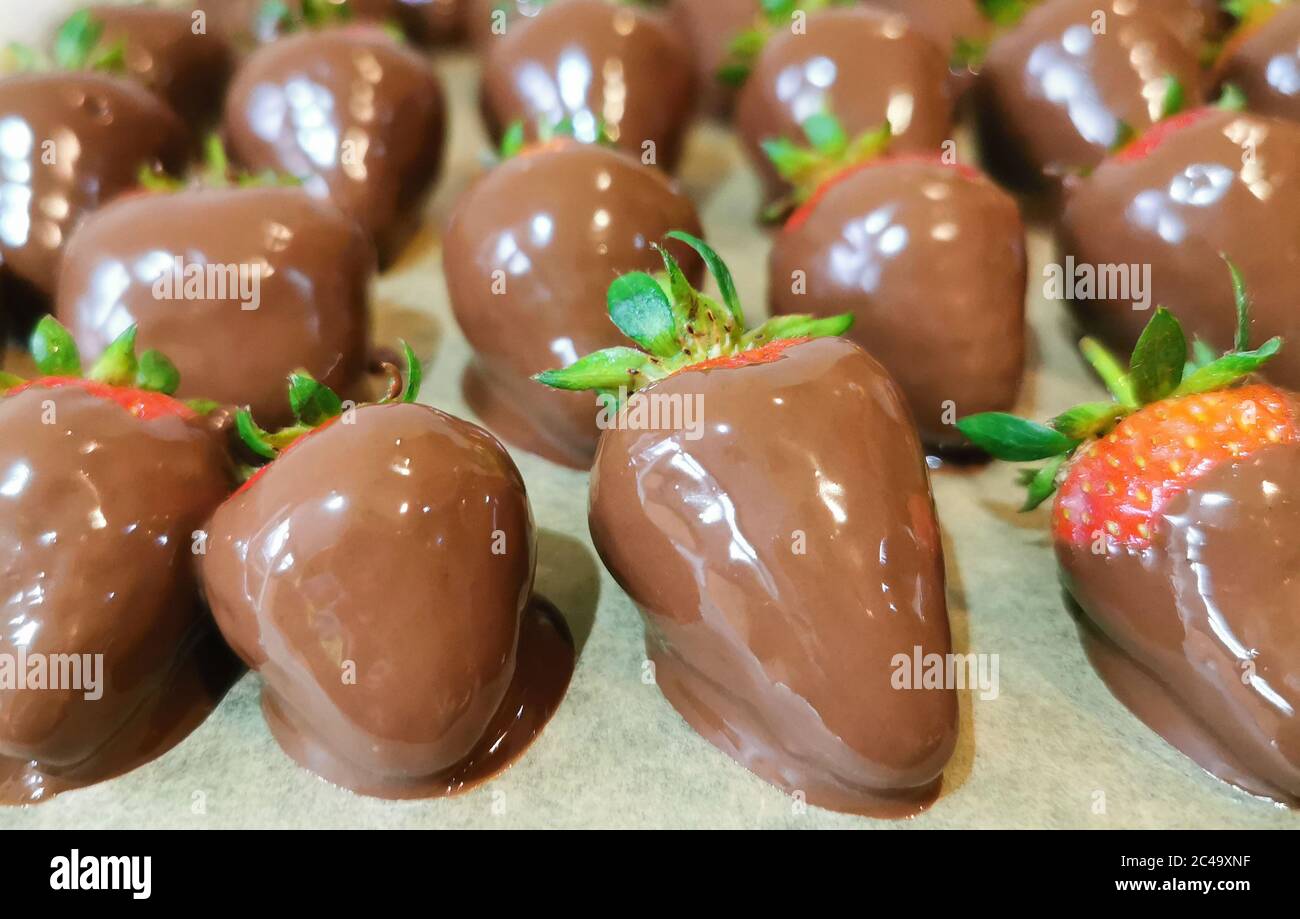 sweet strawberries dipped in chocolate and ready to eat Stock Photo