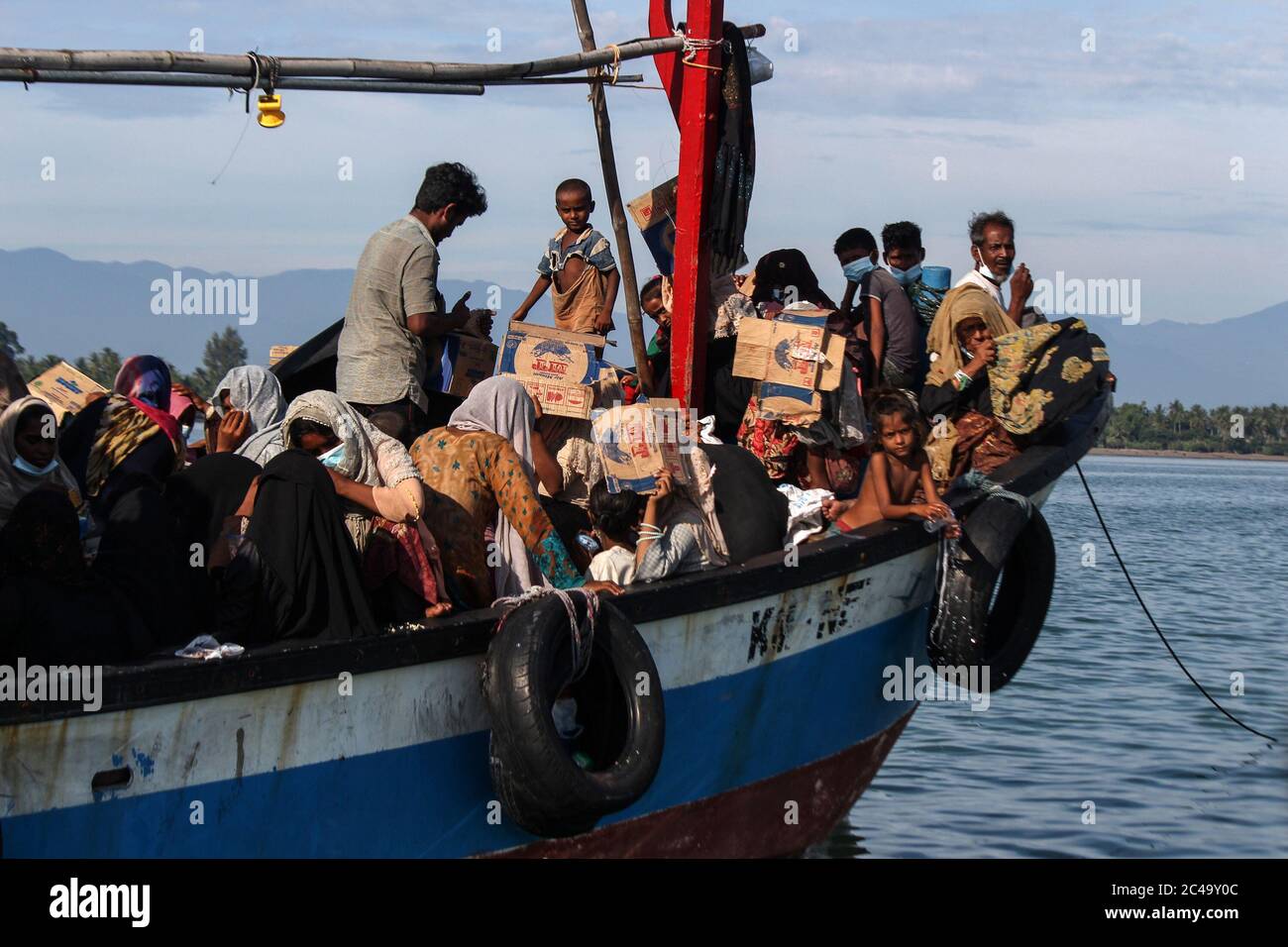 Aceh Utara, Indonesia. 25th June, 2020. A wooden boat seen 1 kilometre from the coast carrying dozens of Rohingya people.According to local officials, as many as 94 Rohingyas were found by Acehnese fishermen stranded in the middle of the sea waters 1 kilometre from the coast off Aceh Province using wooden boats. Credit: SOPA Images Limited/Alamy Live News Stock Photo