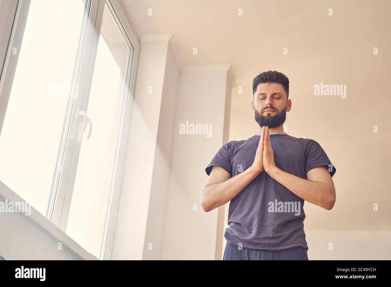 Handsome young man meditating hi-res stock photography and images - Alamy