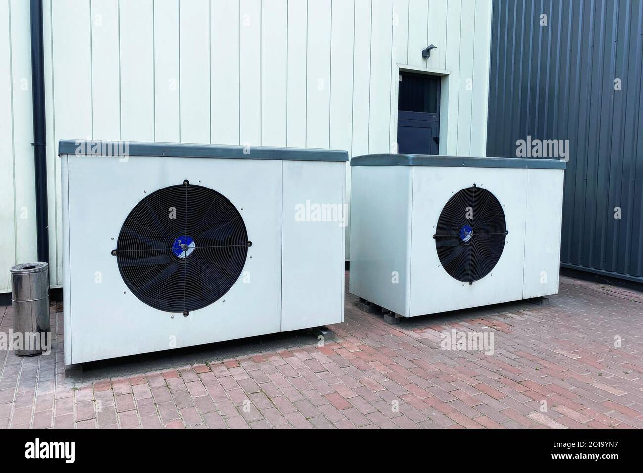 Industrial fan turbine background. Air conditioner condenser fan units battery set climate control. Refrigeration temperature conditioning system. Stock Photo