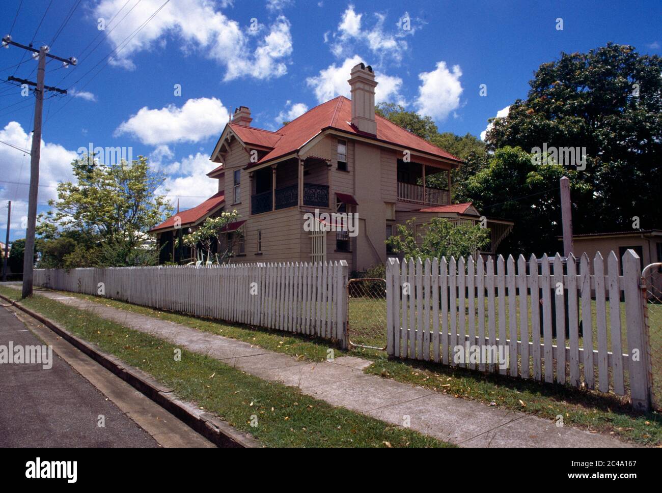Brisbane Queensland Australia House with a White Picket Fence in the Suburbs Stock Photo