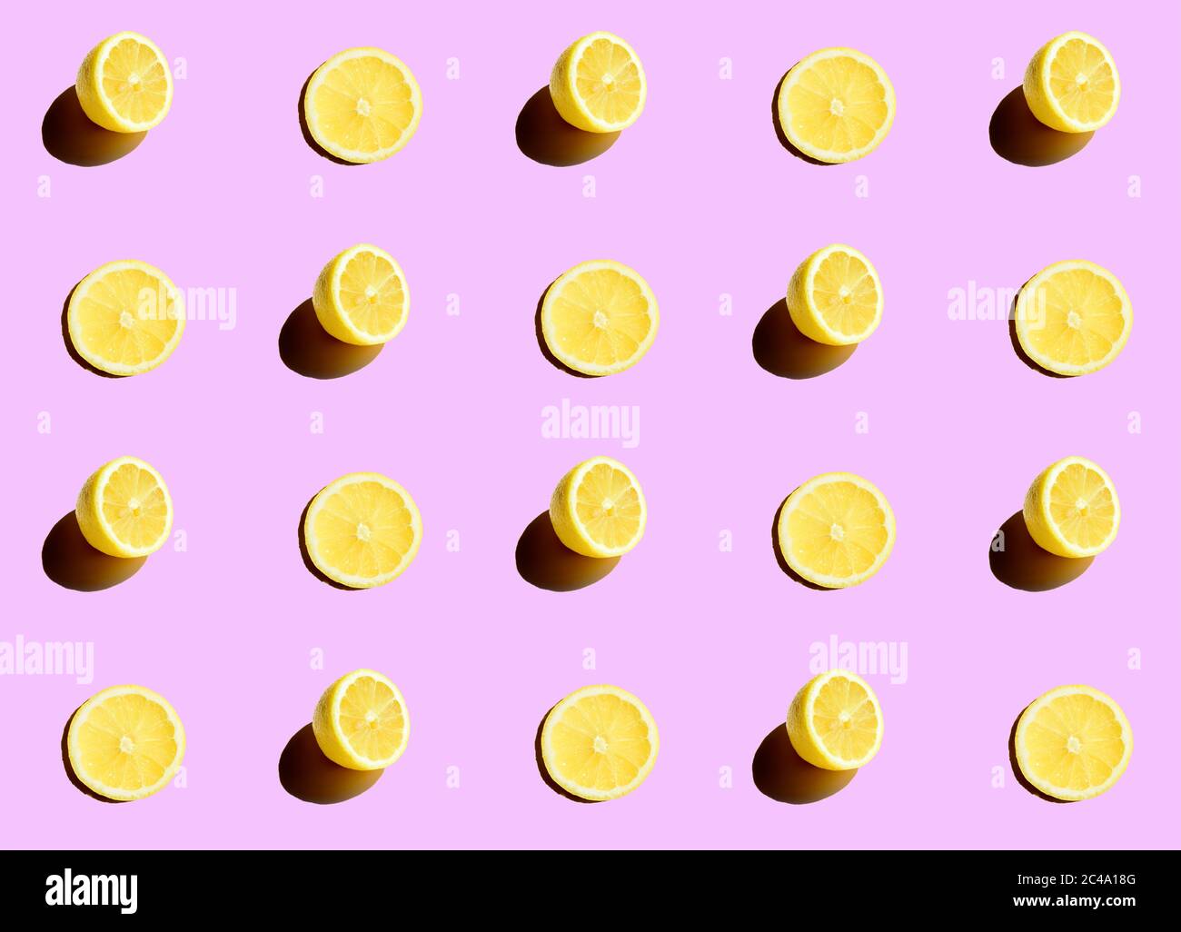 Series of half cut lemons on a purple background Stock Photo
