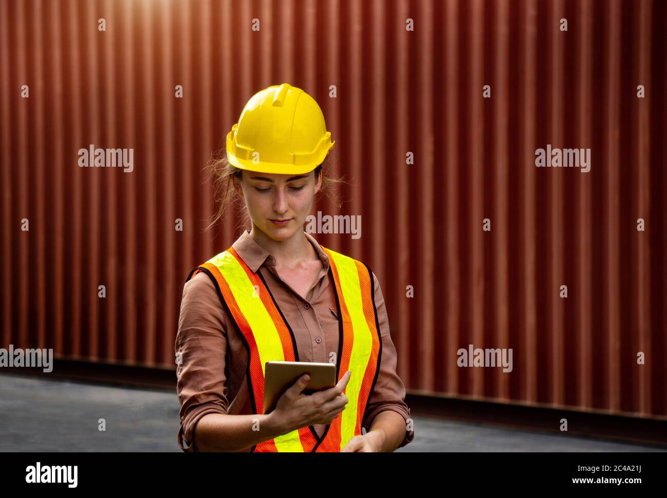 Female foreman is using computer tablet to control work in industrial business Stock Photo