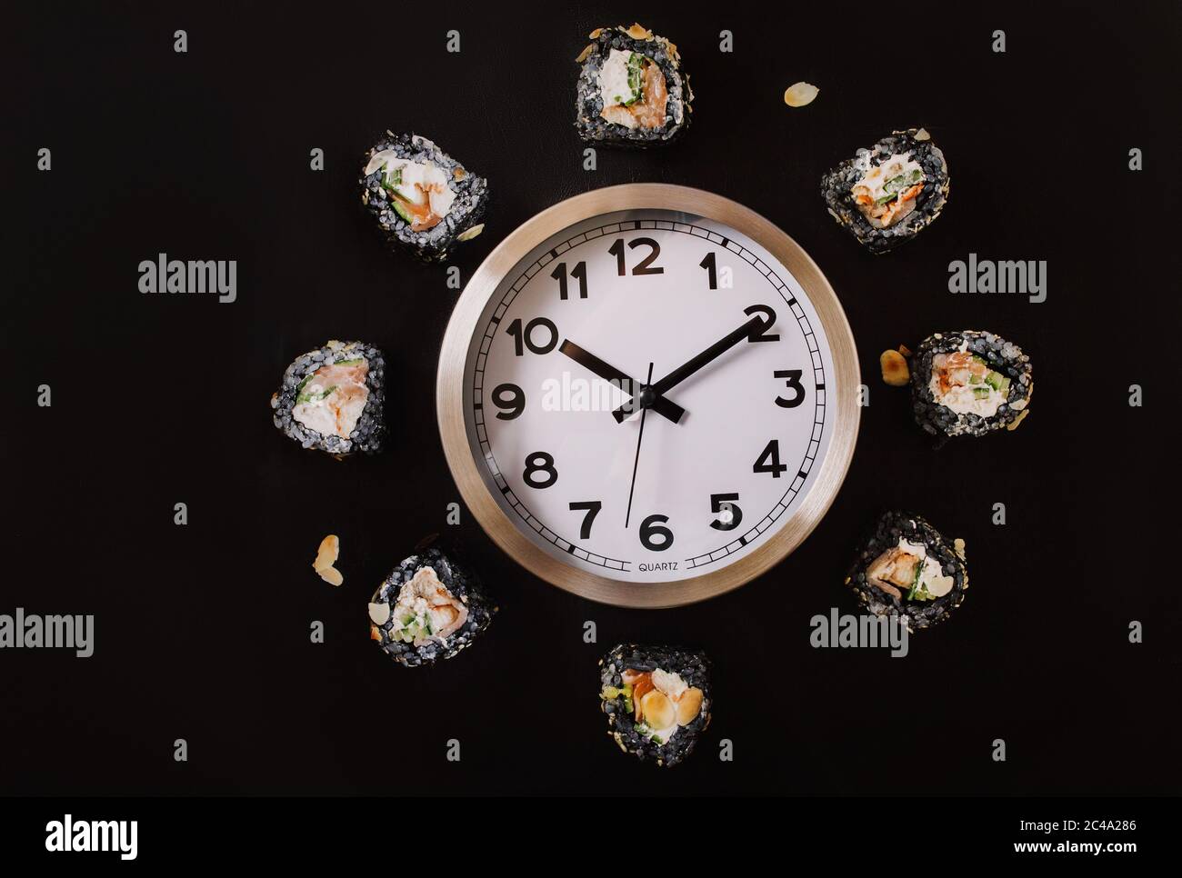 Sushi time in the form of a wall clock on a concrete background. Sushi clock. Place for text Stock Photo