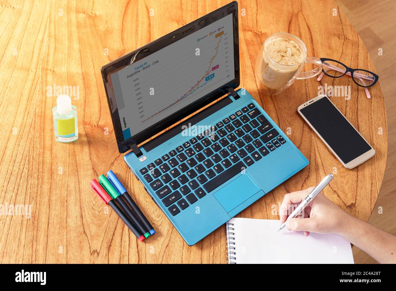 Coronavirus. Person making notes while working at home during quarantine..Top View Stock Photo