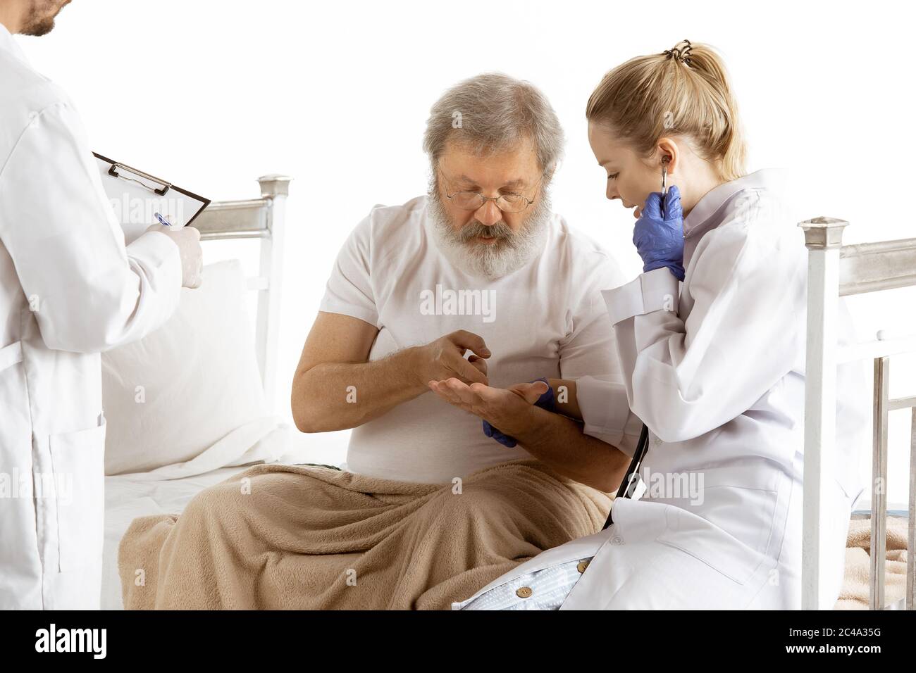 Elderly old man recovering in hospital bed isolated on white background