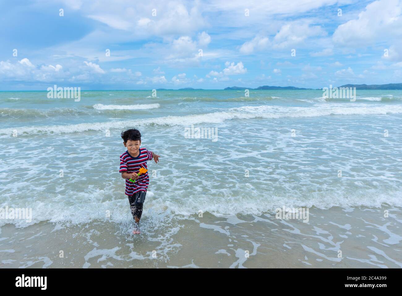 Happy asian family playing at the beach hi-res stock photography and ...