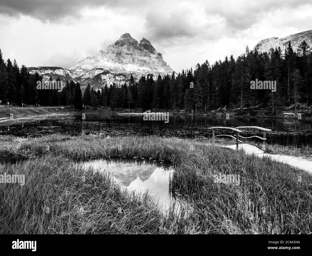 Tre Cime di Lavaredo Mountain reflected in water od Antorno Lake, Dolomites, Italy. Black and white image. Stock Photo