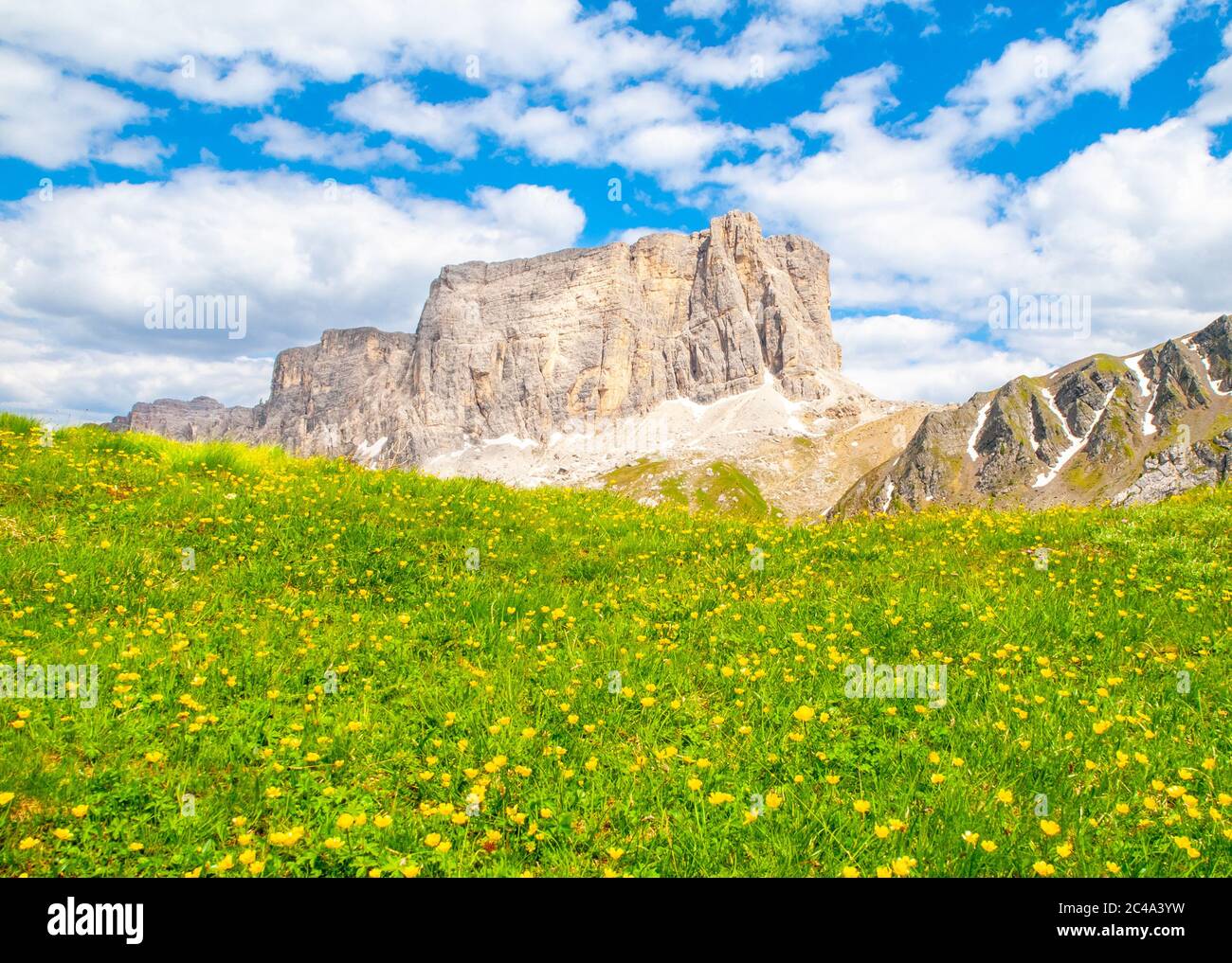 Lastoni de Formin, aka Ponta Lastoi de Formin. Giant mountain block with blooing meadow and summer sky, Dolomites, Italy. Stock Photo