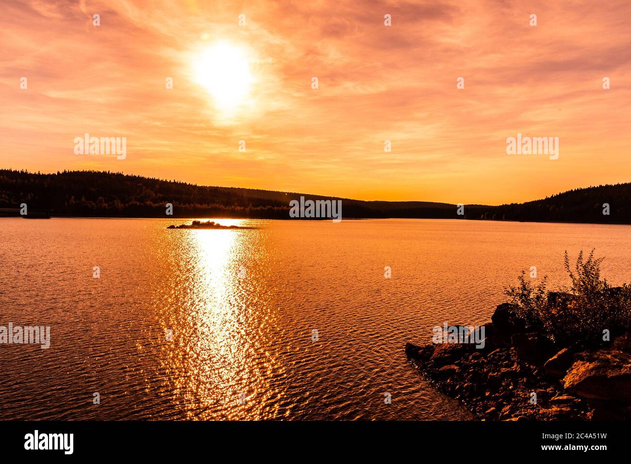 Sunset reflected in water. Josefuv Dul Dam, Jizera Mountains, Czech Republic. Stock Photo