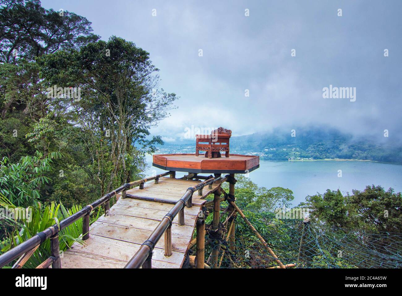 Hanging chair from a cliff is one of the tourist attraction here facing Boyan Lake in Bali Stock Photo