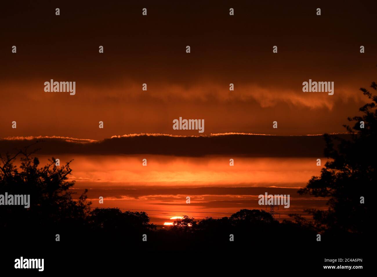 The Sunrises over Essex farmland for the Summer Solstice. The sun rose at 4:41am to mark the start of the longest day of the year in the Northern hemi Stock Photo