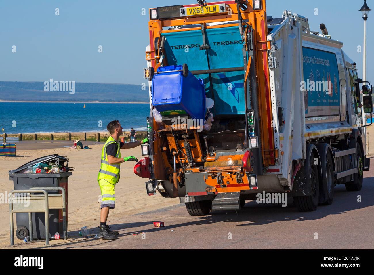 Rubbish left behind and being collected on the hottest day of the year during heatwave at Bournemouth beach, Dorset UK in June - litter garbage Stock Photo
