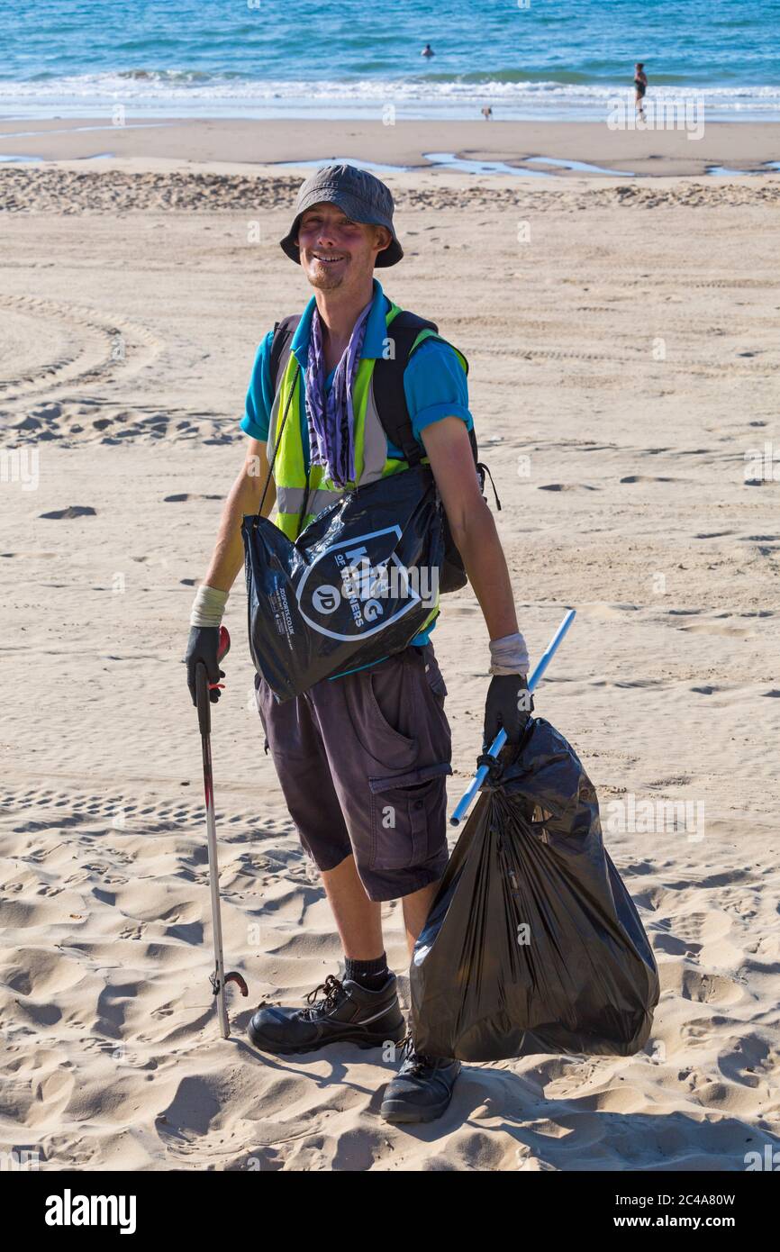 Council worker picking up rubbish left behind on the hottest day of the