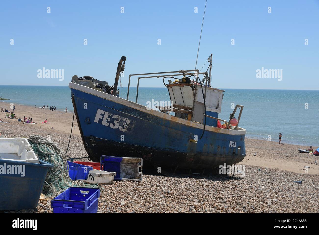 Visitors to Hastings have no problems with social distancing on the hottest day of the year so far as the UK heatwave continues. Stock Photo