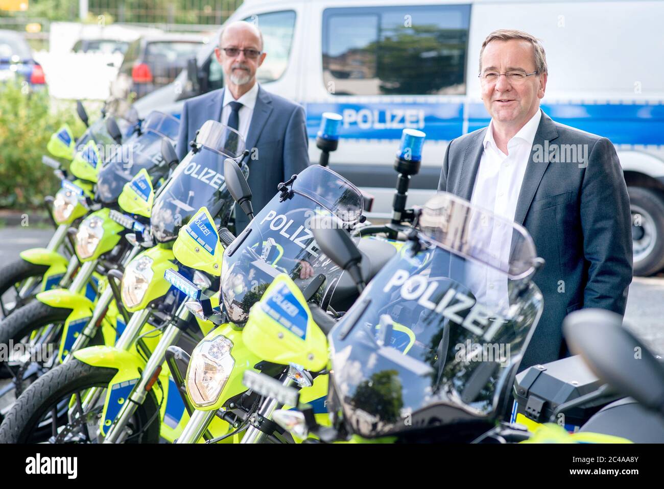 Hanover, Germany. 25th June, 2020. Boris Pistorius (r, SPD), Minister of the Interior in Lower Saxony, and Volker Kluwe, Police Commissioner of the Hanover Police Department, stand between new police motorcycles. The Ministry of the Interior and the Hanover Police Headquarters have presented the results of an optimization analysis for the police's presence and intervention capability. Credit: Hauke-Christian Dittrich/dpa/Alamy Live News Stock Photo