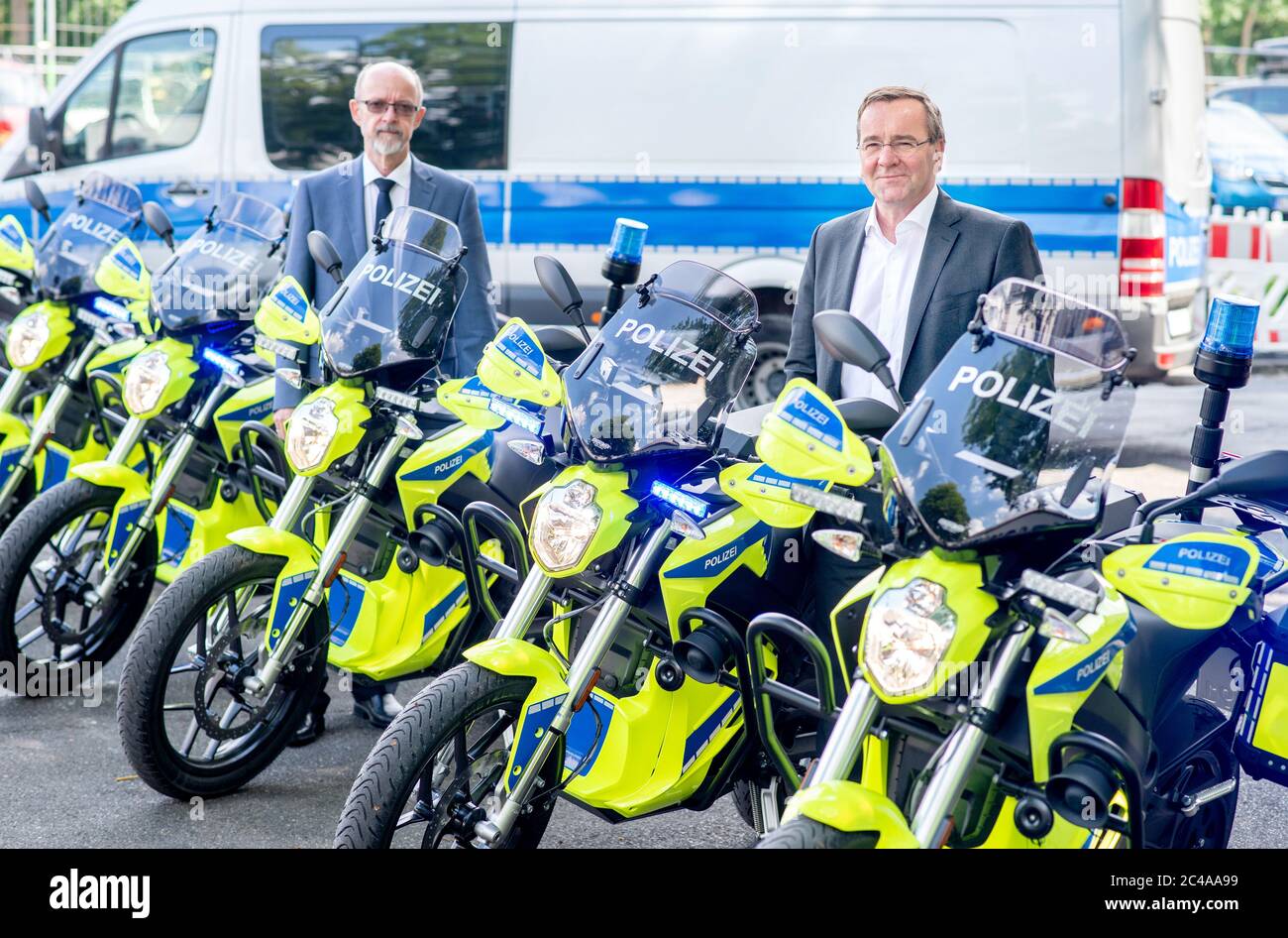 Hanover, Germany. 25th June, 2020. Boris Pistorius (r, SPD), Minister of the Interior in Lower Saxony, and Volker Kluwe, Police Commissioner of the Hanover Police Department, stand between new police motorcycles. The Ministry of the Interior and the Hanover Police Headquarters have presented the results of an optimization analysis for the police's presence and intervention capability. Credit: Hauke-Christian Dittrich/dpa/Alamy Live News Stock Photo